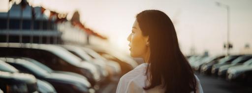 Woman at car lot