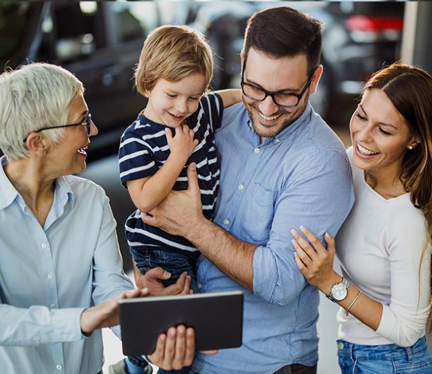 Family and salesperson looking at tablet