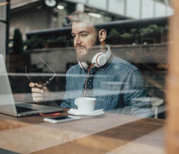 Person looking at laptop in cafe
