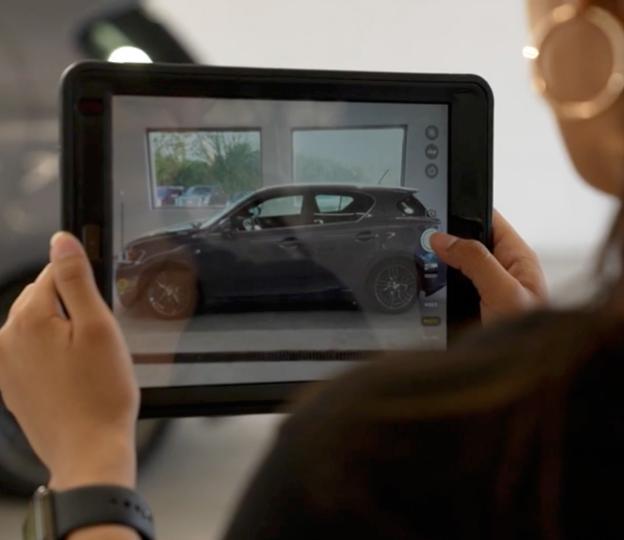 Service advisor reviewing car with tablet
