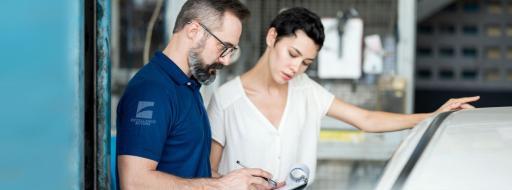 man and woman looking at car