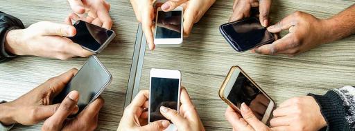 hands holding phones